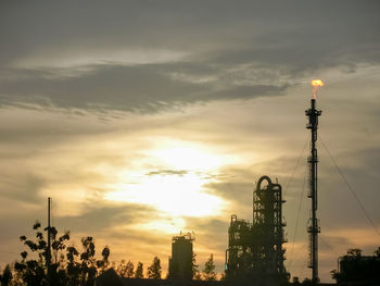 Low angle view of silhouette crane against sky during sunset