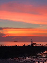 Scenic view of sea against orange sky