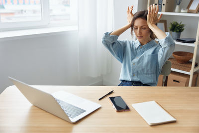 Portrait of young woman working in office