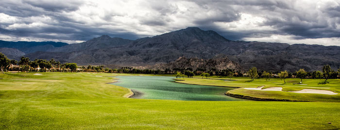 Scenic view of mountains against cloudy sky