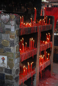 Illuminated candles in temple building