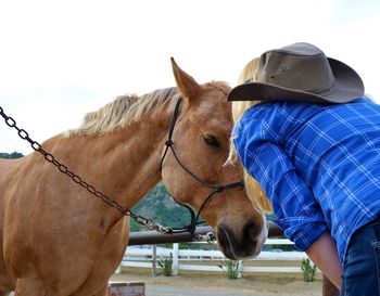 Woman with horse at farm