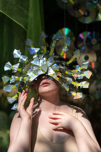 Close-up of woman holding reflective accessory