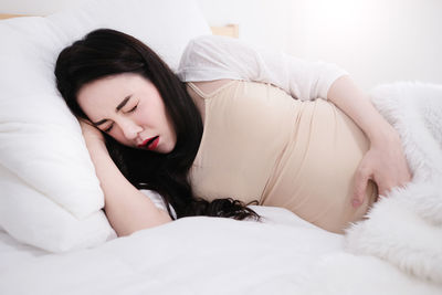 Young woman sleeping on bed