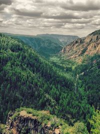 Scenic view of mountains against cloudy sky