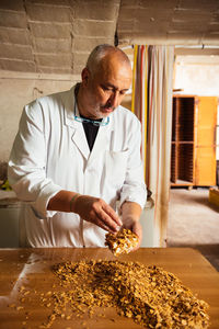 Side view of man working in kitchen