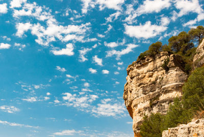 Low angle view of rock formation against sky