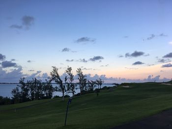 Scenic view of golf course against sky