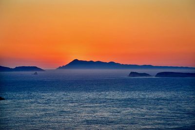 Scenic view of sea against romantic sky at sunset