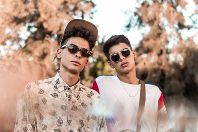 Portrait of young men wearing sunglasses