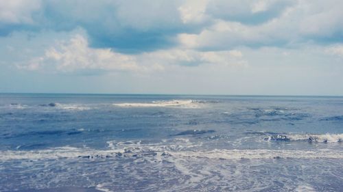 Scenic view of sea against cloudy sky