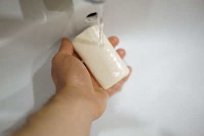 High angle view of hand holding ice cream