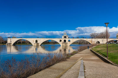 Bridge over river against blue sky