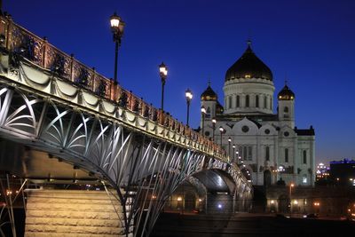 Low angle view of illuminated bridge against sky