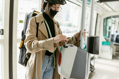 Midsection of woman standing in bus