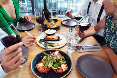 Midsection of woman holding food on table