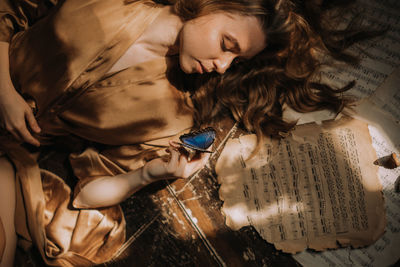 High angle view of woman lying on bed