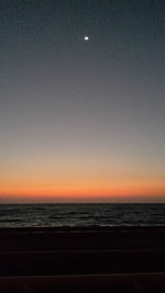 Scenic view of sea against clear sky at night