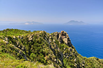 Scenic view of sea and mountains against sky