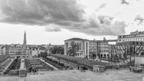 Buildings in city against cloudy sky