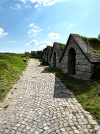 Built structure on field against sky