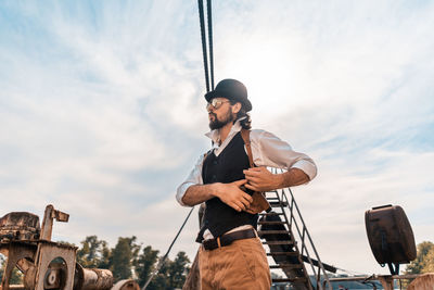 Low angle view of man standing against sky