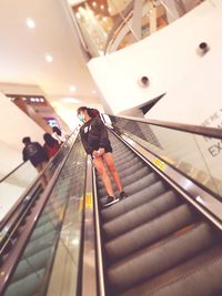 High angle view of woman on escalator