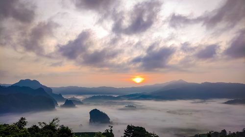 Scenic view of silhouette mountains against sky during sunset