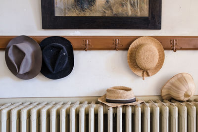Hats above radiator against wall