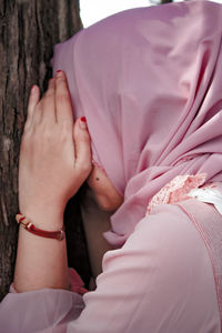 Close-up of woman hand with pink flowers