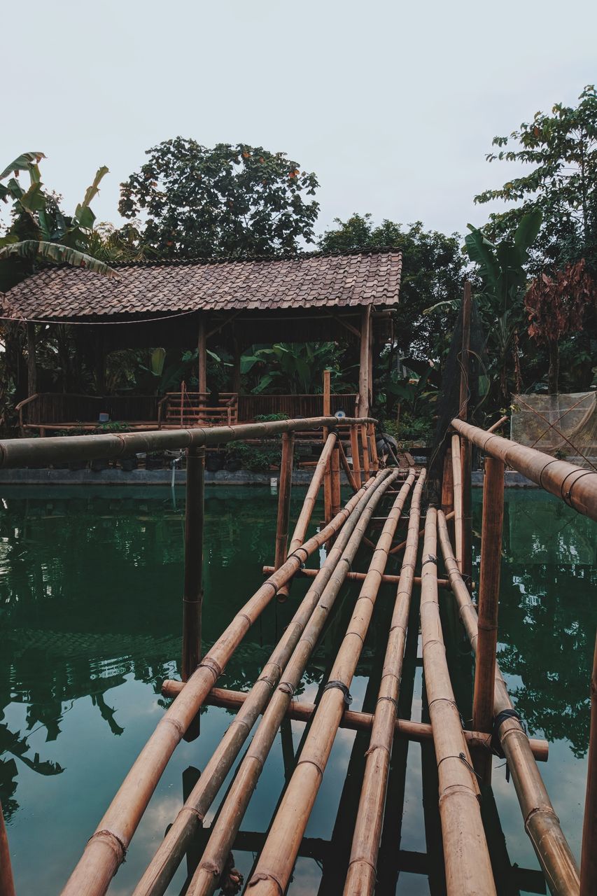 WOODEN BRIDGE OVER RIVER