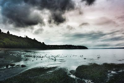 Scenic view of sea against cloudy sky