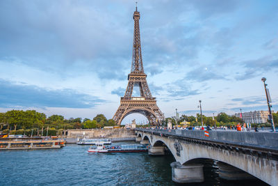 View of bridge over river against cloudy sky