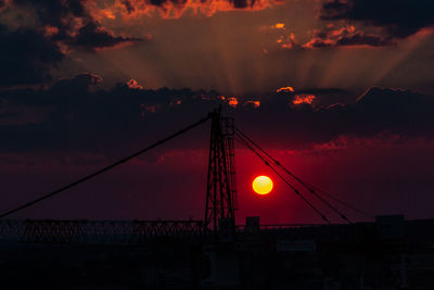 Low angle view of silhouette bridge against sky during sunset