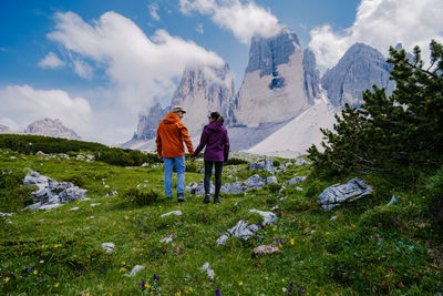 Rear view of people on mountains against sky