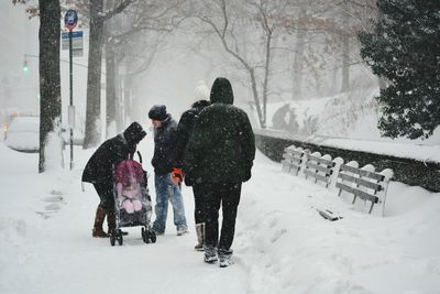 People standing on snow covered landscape