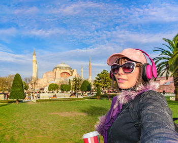 Portrait of smiling woman against hagia sophia museum