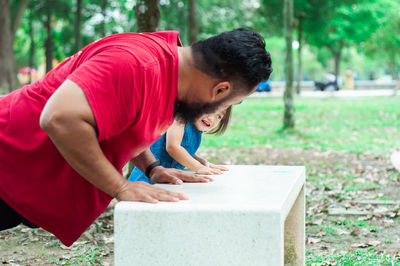 Father workout with toddler at the park.