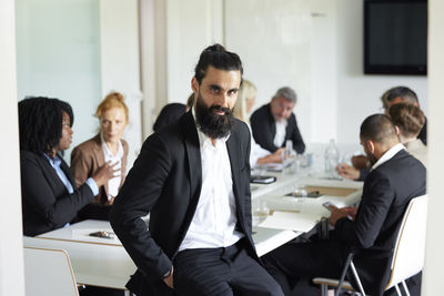 Businessman in boardroom looking at camera