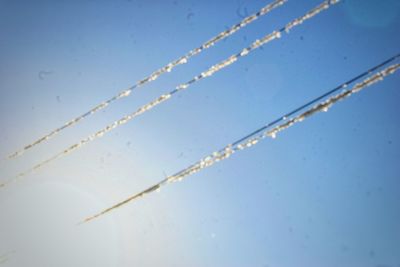 Close-up of ice against blue sky