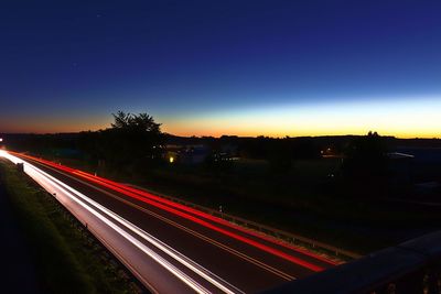 High angle view of light trails on road at night