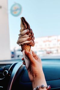 Close-up of woman hand holding car