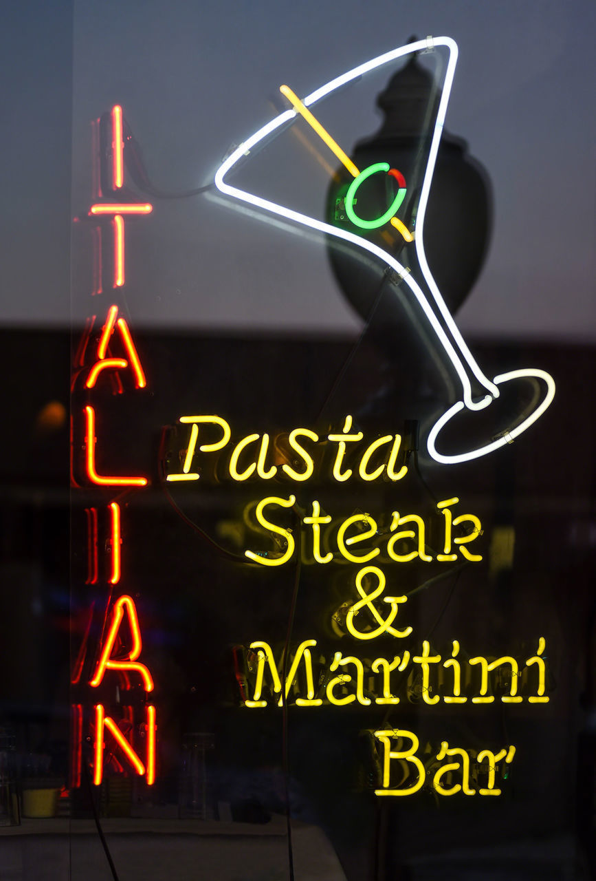 LOW ANGLE VIEW OF ILLUMINATED INFORMATION SIGN ON GLASS