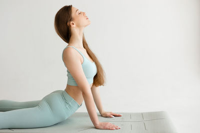 Beautiful girl doing an exercise for correct posture