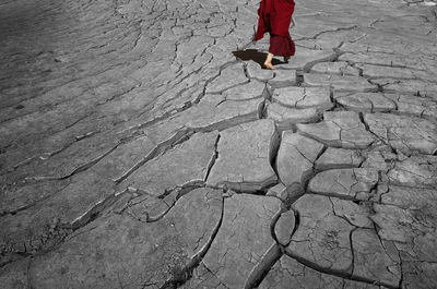 Low section of woman walking on barren land