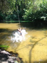 Person on swing in water