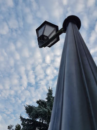 Low angle view of cross against sky