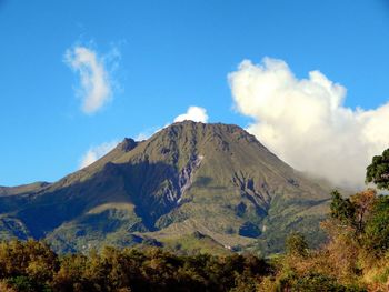 Panoramic view of mountains against blue sky