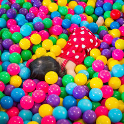 High angle view of girl playing with ball balls