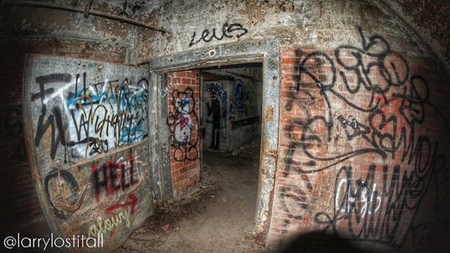 graffiti, architecture, built structure, art, text, art and craft, creativity, wall - building feature, western script, old, abandoned, wall, street art, building exterior, vandalism, indoors, deterioration, weathered, damaged, door